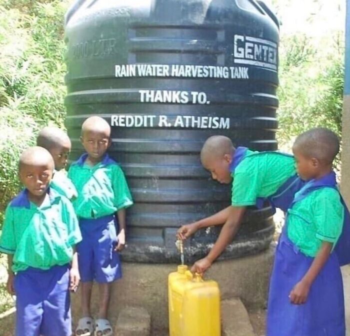 Children collecting water from rain harvesting tank funded by Reddit atheism