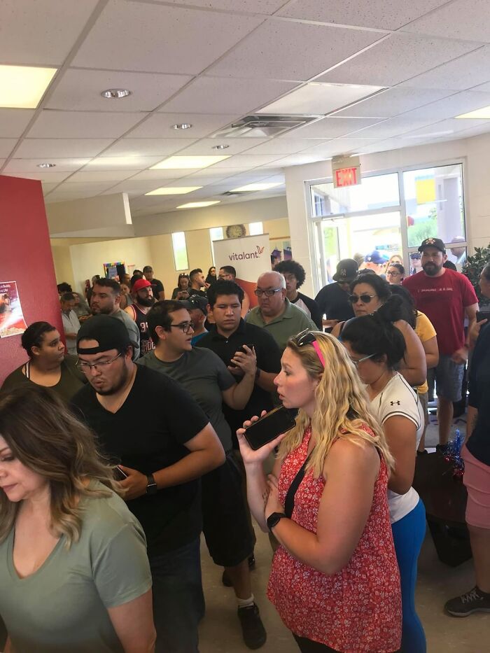 Crowd of diverse people waiting in line inside Vitalant blood donation center