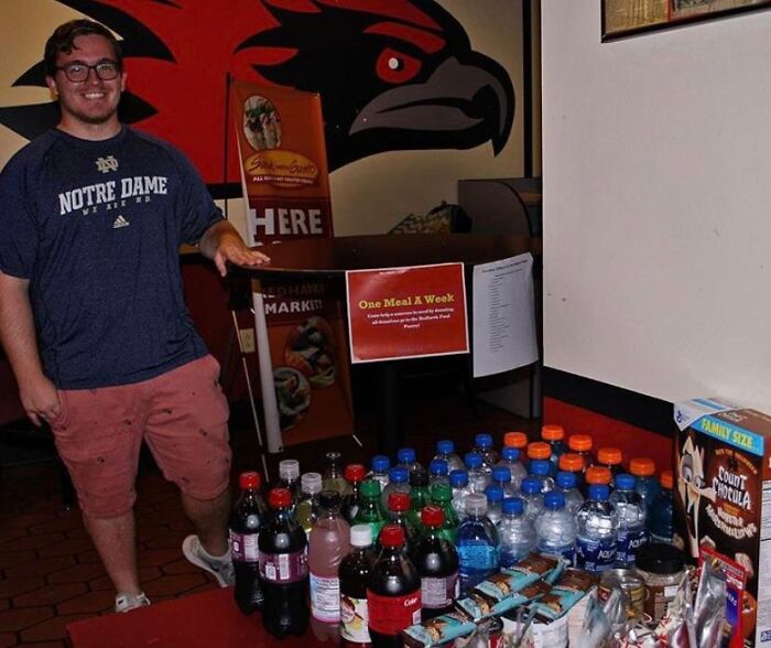 Man standing by table with drinks and snacks for charity event