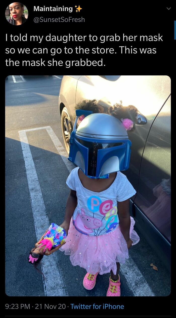 Child wearing Star Wars helmet mask in cute wholesome moment