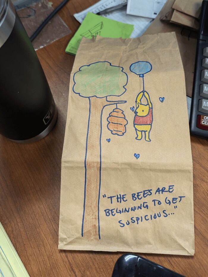 Hand-drawn Winnie the Pooh on paper bag with bees and honeycomb