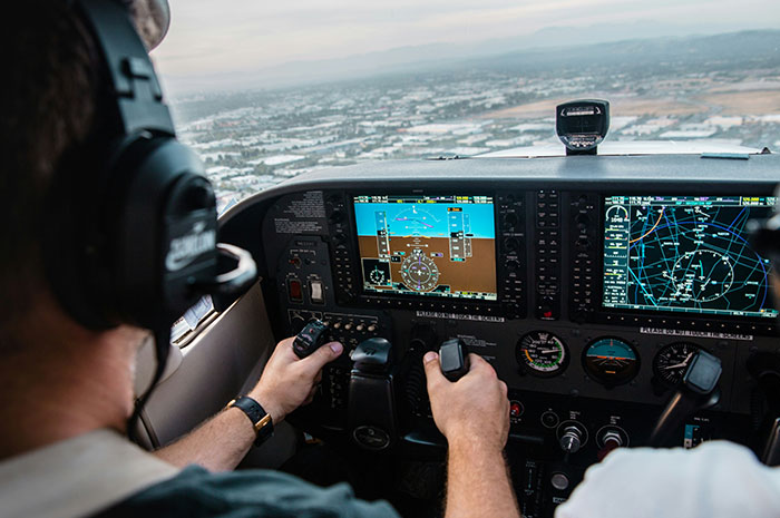Pilot controlling aircraft cockpit showing career realities and risks