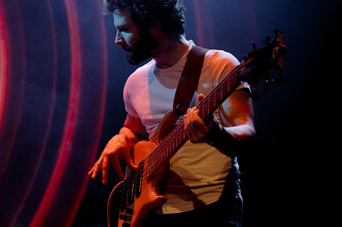 Musician playing guitar on stage highlighting career struggles