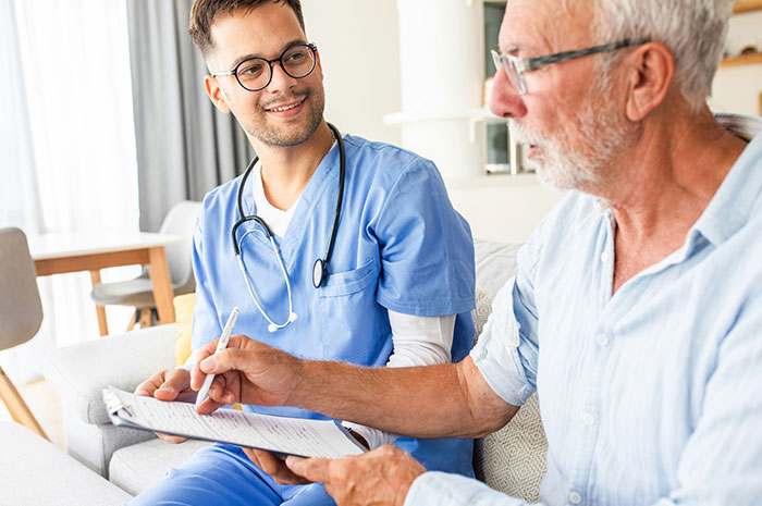 Healthcare professional consulting elderly patient in medical career