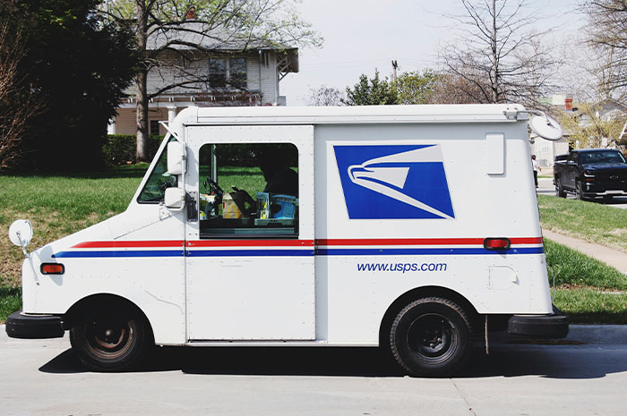 USPS mail delivery truck parked on residential street