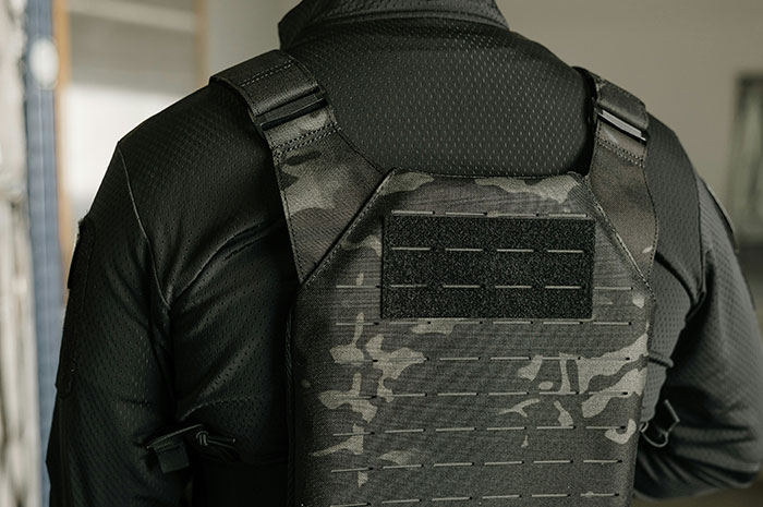 Person wearing tactical body armor depicting risks in security professions