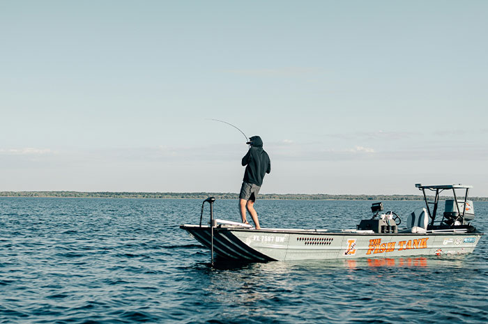 Angler fishing from boat illustrating fishing career dangers