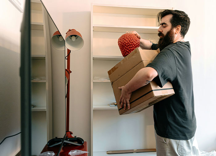 Man packing belongings, symbolizing fallout from spying