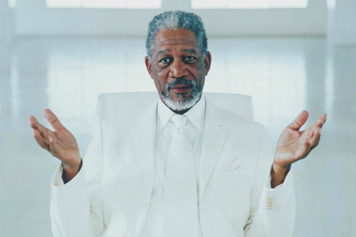 Morgan Freeman, dressed in a white suit, shrugging with open hands. Illustrates how weddings went off the rails.