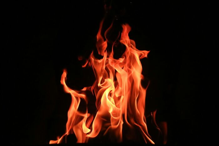Vibrant orange and red flames dance against a dark, black background, symbolizing fiery weddings that went off the rails.