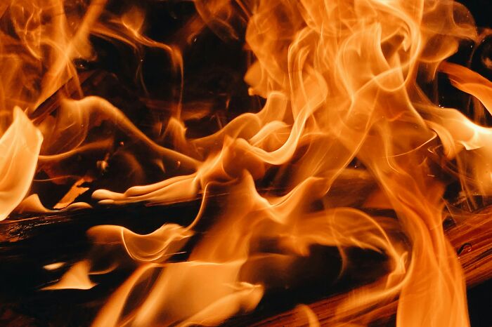 Bright orange and yellow flames dance on a dark background, evoking the intensity of weddings going off the rails.