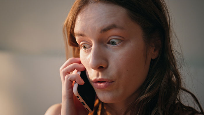 Worried woman on phone about toxic MIL allergen case Worried woman on phone about toxic MIL allergen case