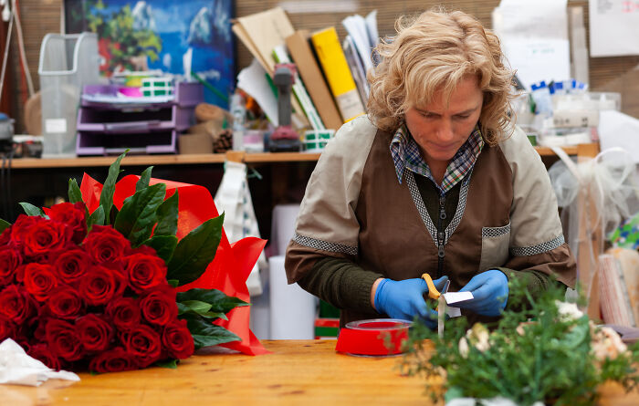 Florist preparing bouquet focusing on peace over paycheck career shift