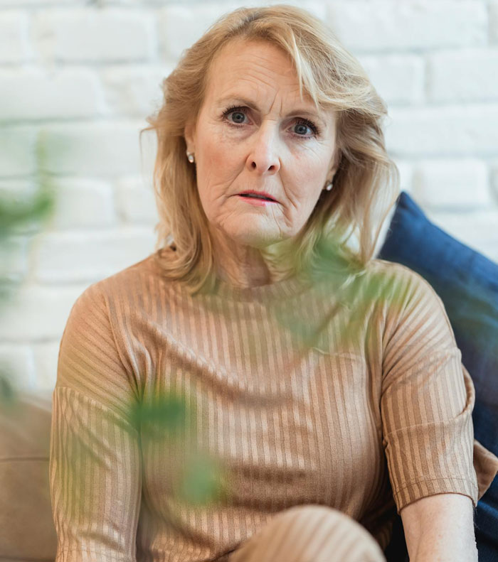 Portrait of a thoughtful older woman sitting indoors Portrait of a thoughtful older woman sitting indoors