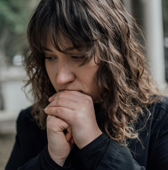 Worried woman with curly hair thinking deeply infertility issue concept Worried woman with curly hair thinking deeply infertility issue concept