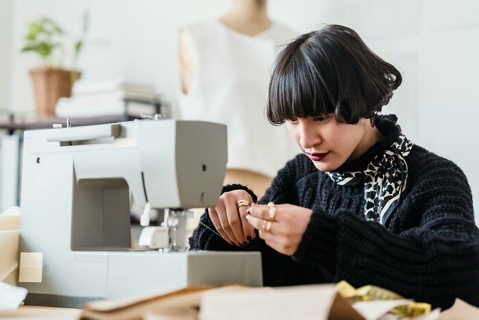 Woman focused on sewing at a machine representing women who quit their horrible jobs for better careers