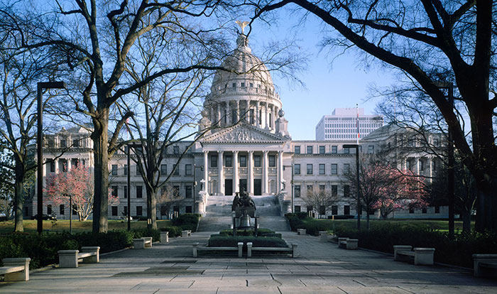 Mississippi State Capitol building with trees in the foreground