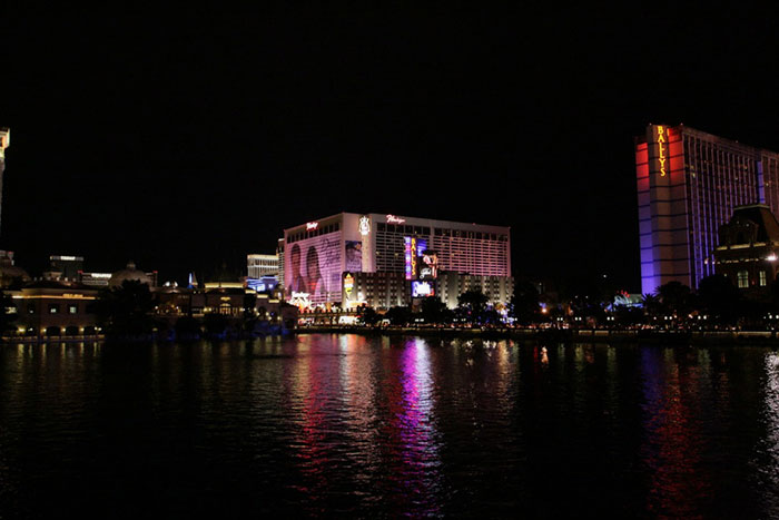 Las Vegas Strip at night with illuminated casinos reflecting on water