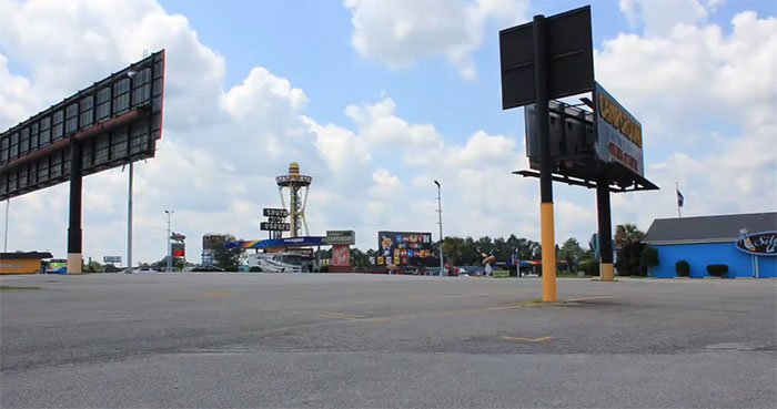 Empty parking lot with billboards and commercial buildings in the US