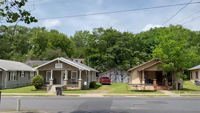 Small residential street with modest houses and greenery in the US