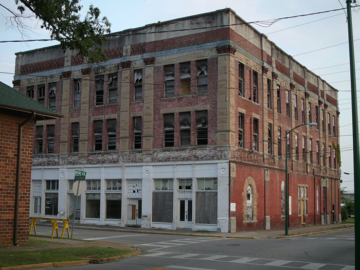 Abandoned multi-story brick building with broken windows in the US
