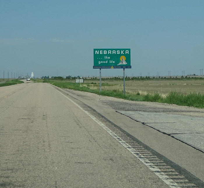 Nebraska roadside sign on a quiet rural highway in the US