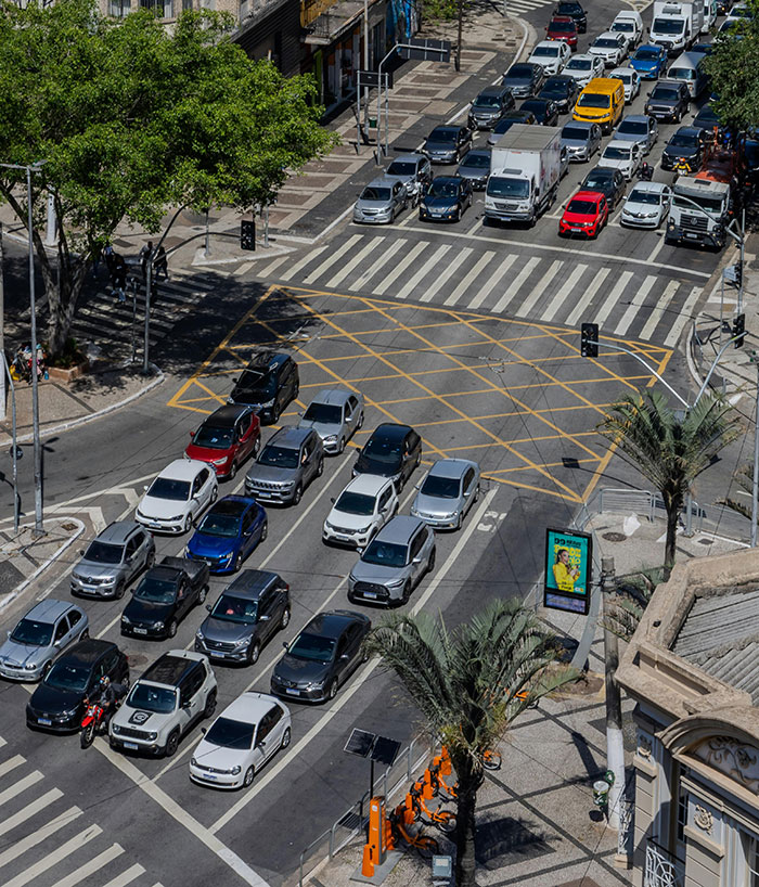 An overhead view of a busy street intersection, with many cars stuck in traffic, showing a potential for road rage.