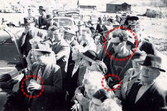 Crowd of people in vintage photo with unexplained circled anomalies