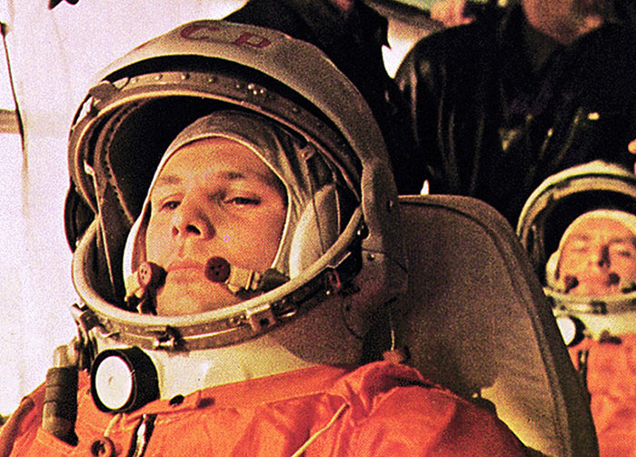 Cosmonaut Yuri Gagarin in his space suit before his historic flight, showing controversial beliefs and arguments.