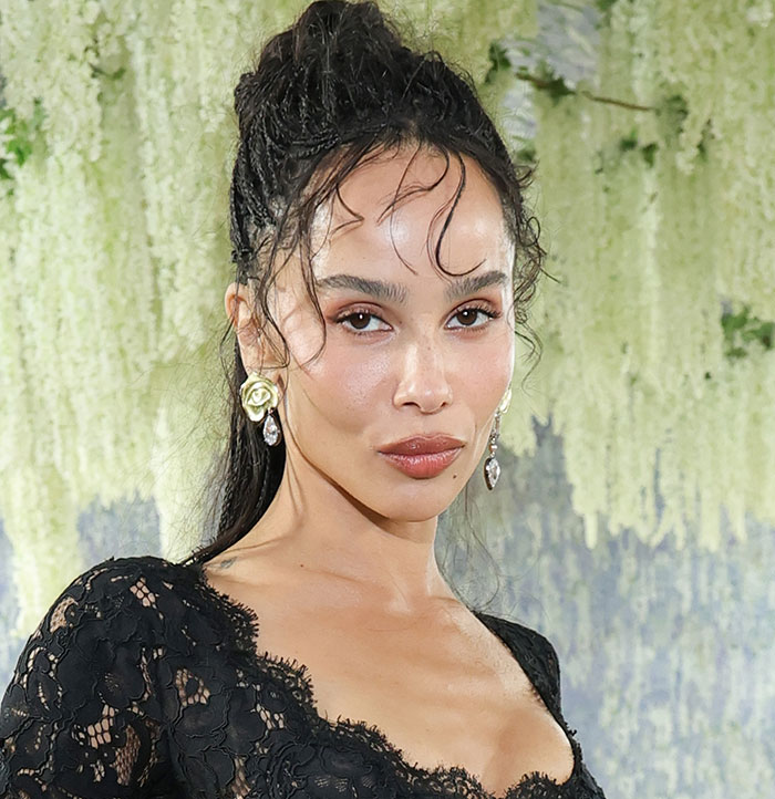 A celebrity showing off subtle plastic surgery, wearing a black lace dress at Met Gala 2026.