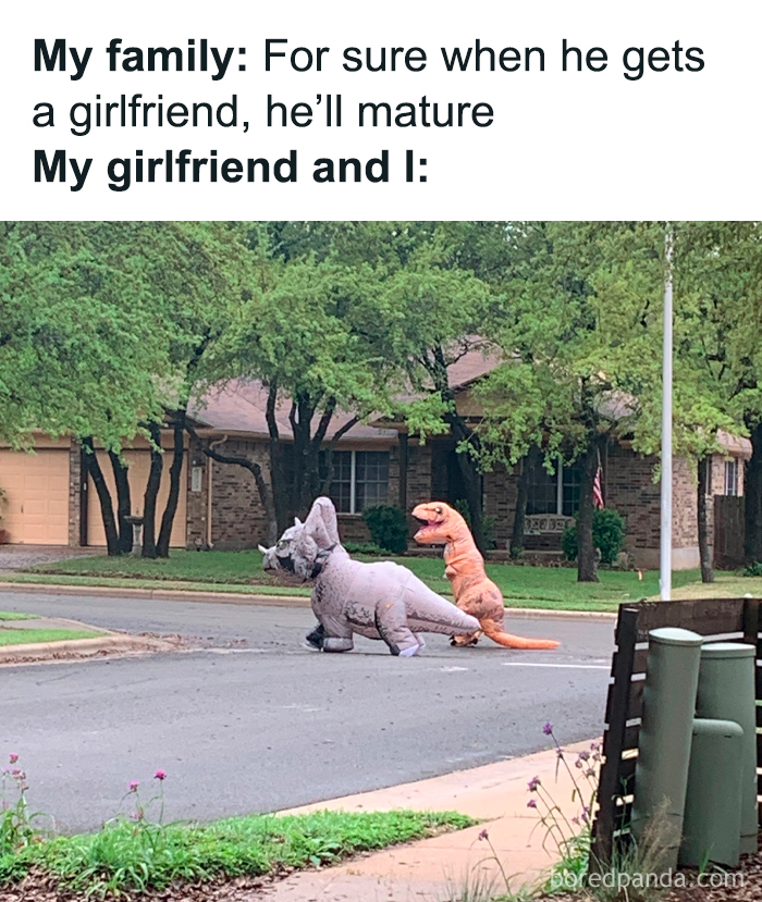 Sweet posts about love: two people in dinosaur costumes crossing the street.