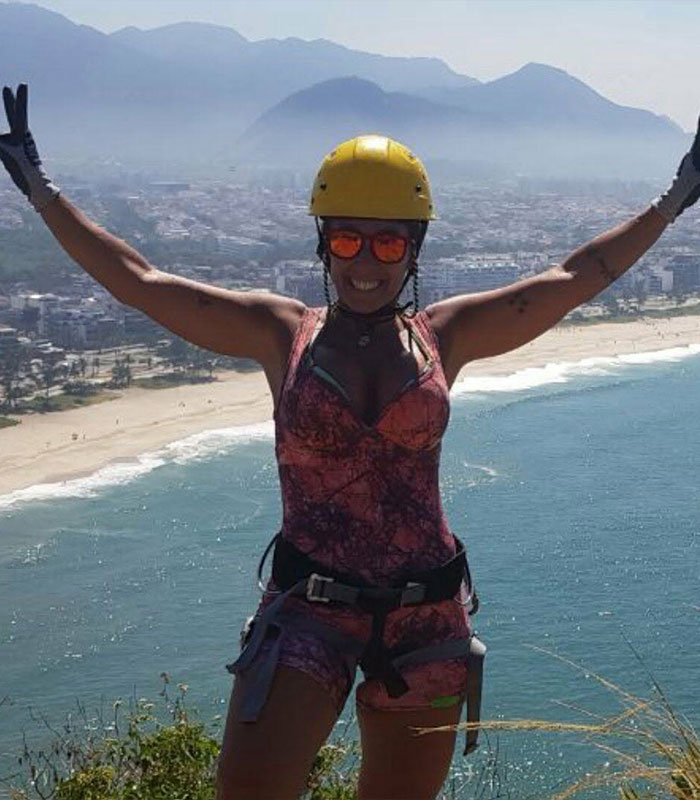 Woman in helmet celebrating with ocean view hiking accident Brazil Woman in helmet celebrating with ocean view hiking accident Brazil