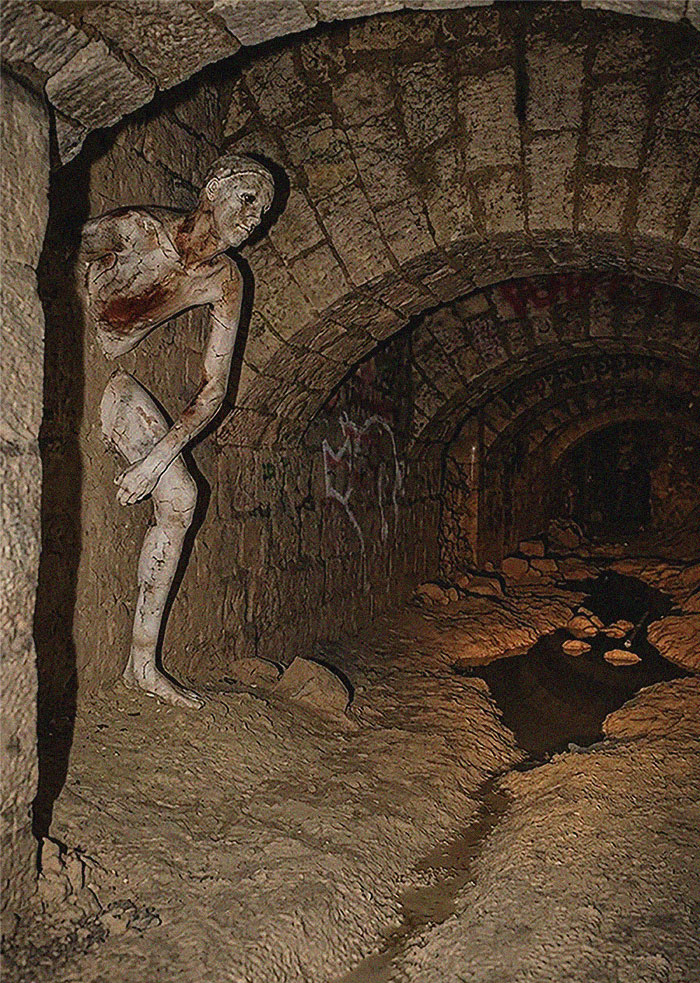 Creepy figure in dark underground tunnel capturing horror movie vibe