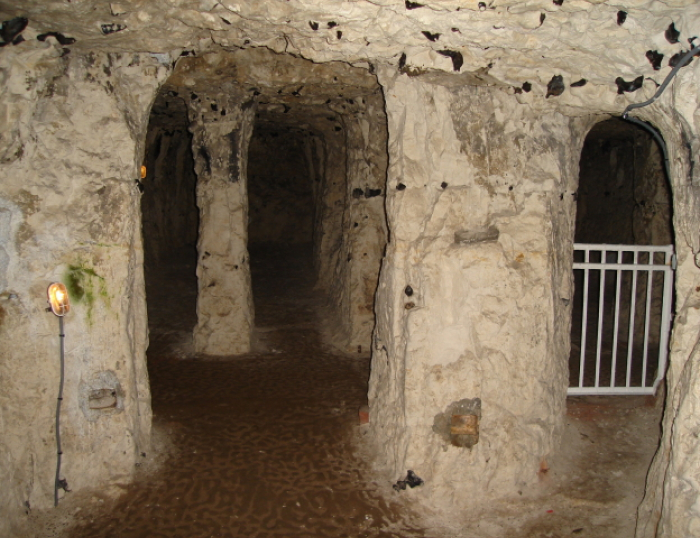 The Underground City Of Naours. Interior tunnel with rocky walls inside a secret underground bunker