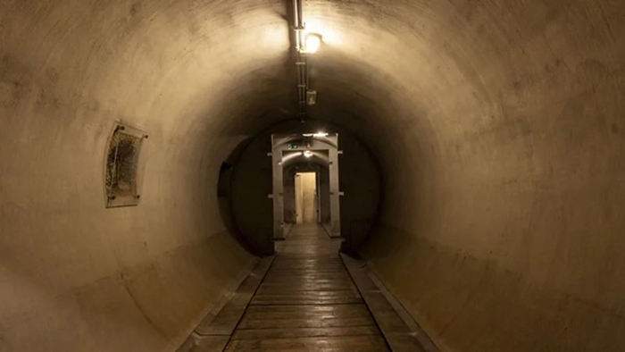 Mussolini's Rome Bunker. Long concrete corridor illuminated with lights inside an underground bunker