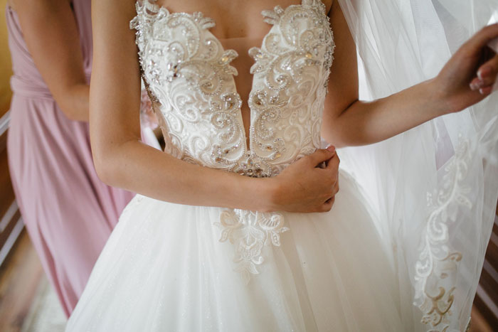 Close-up of a bride in an elegant white wedding gown, preparing for her wedding day. Close-up of a bride in an elegant white wedding gown, preparing for her wedding day.