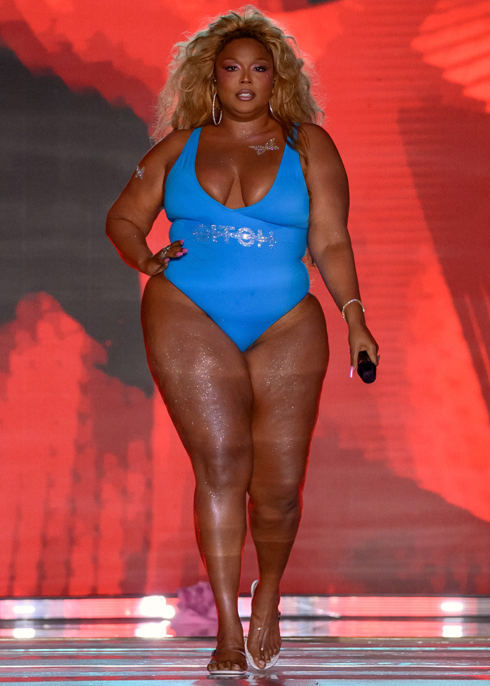 Plus-size model in blue swimsuit performing at Sports Illustrated runway 2026