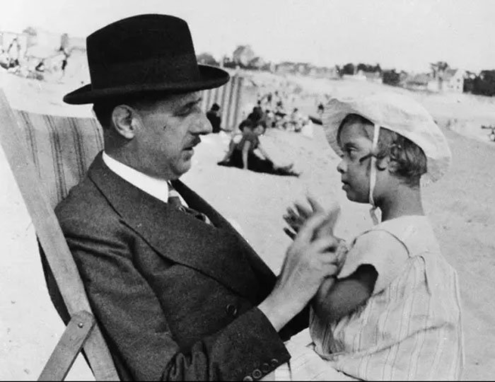 Vintage photo of world leader interacting with child at beach