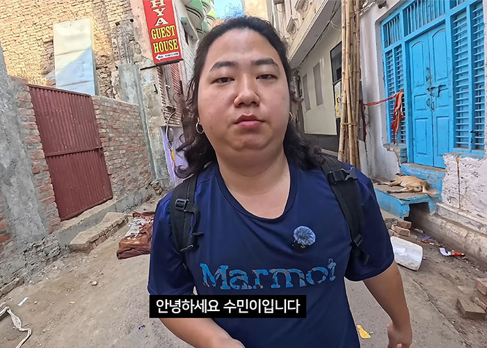 Korean man exposing gender violence in India walking down narrow street