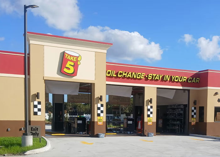 Take 5 oil change service center exterior with stay in your car sign Take 5 oil change service center exterior with stay in your car sign