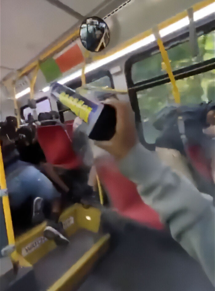 Passenger on bus holding can with class clown consequences vibe