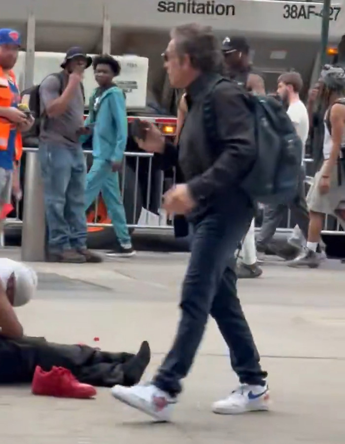 Ben Stiller walking past a homeless person on street Ben Stiller walking past a homeless person on street