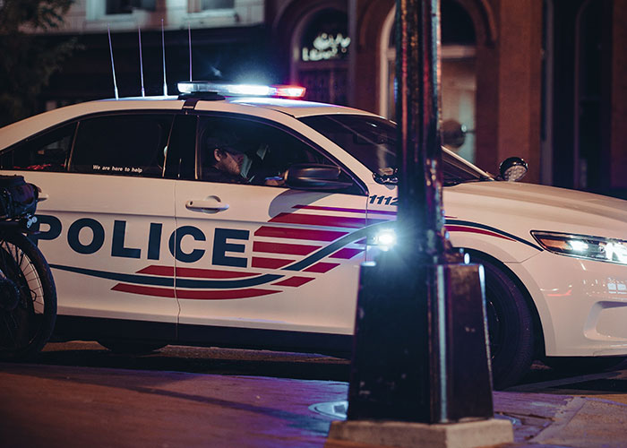 Police car with flashing lights indicating moments to leave immediately