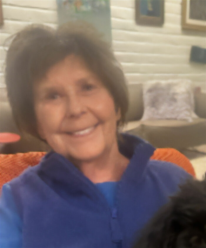 A smiling woman with dark hair in a casual setting, her happy expression contrasting with unsolved mysteries.