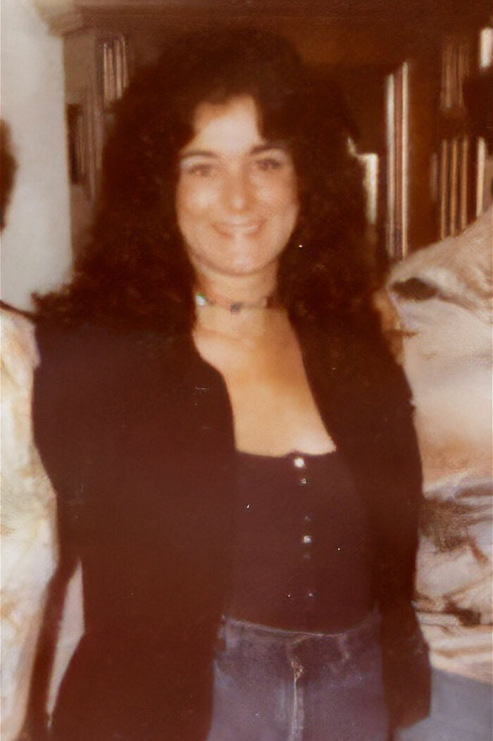 A smiling woman with dark, curly hair, her expression suggesting a personal story of unsolved mysteries.