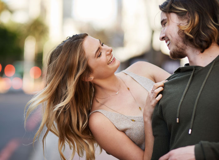 A happy couple smiling at each other, representing myths about men and women.