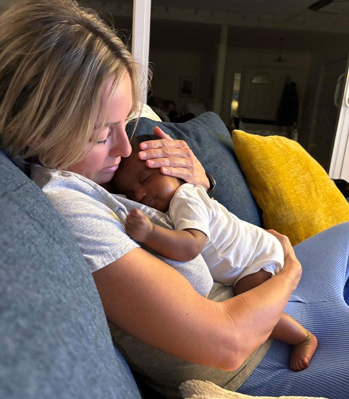 An IVF mother holding her baby close, sleeping peacefully on her chest. IVF baby mix-up.