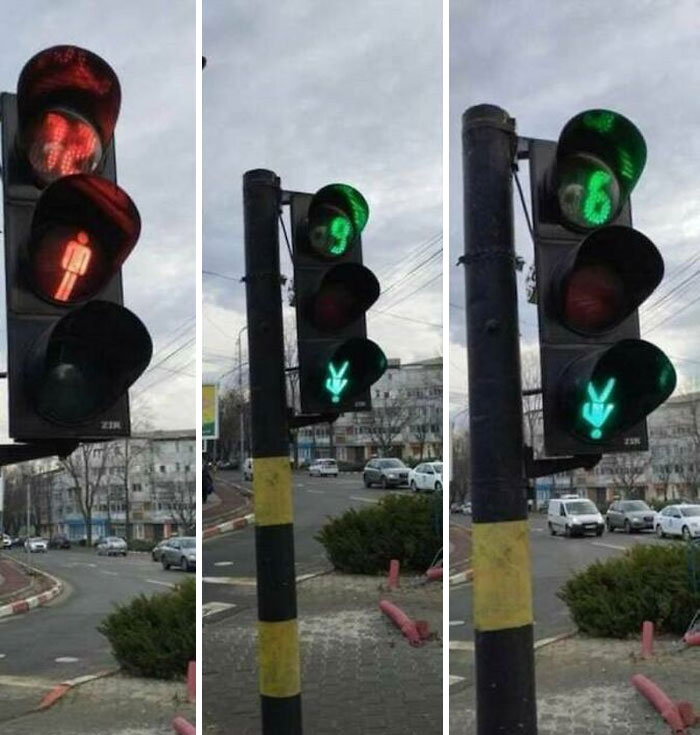A traffic light displaying a green walking person, but a red hand for cars, a ridiculous you had one job fail.