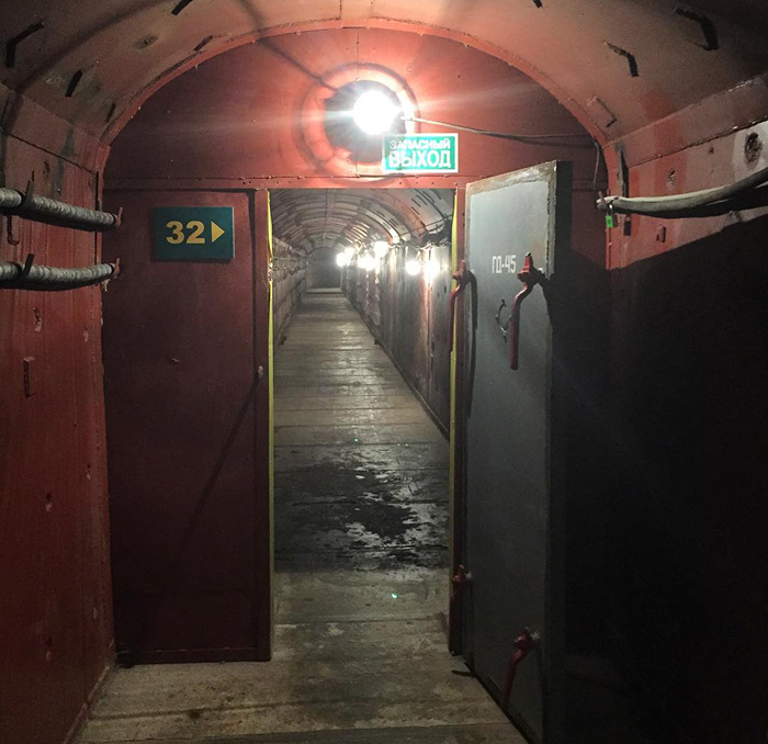 Josef Stalin's Bunker-42. Dimly lit underground bunker corridor with open heavy door