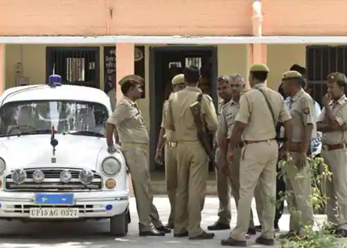 Police officers gathered near a police car at a job interview incident